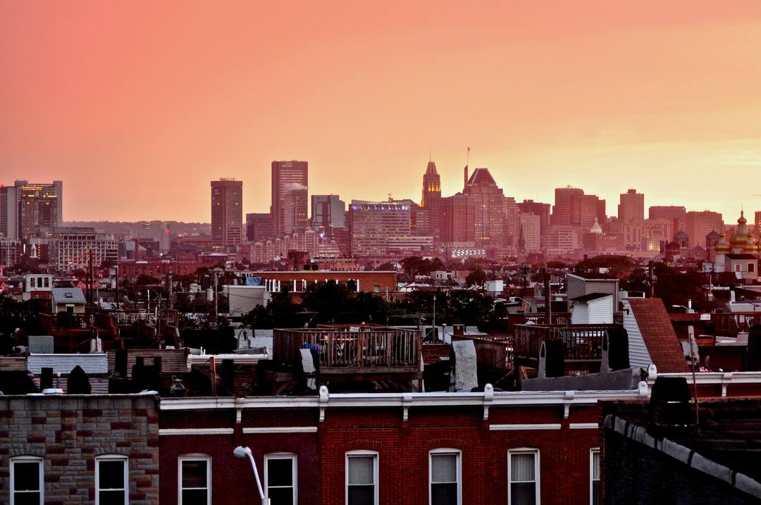 Baltimore's downtown skyline above rowhouse rooftops